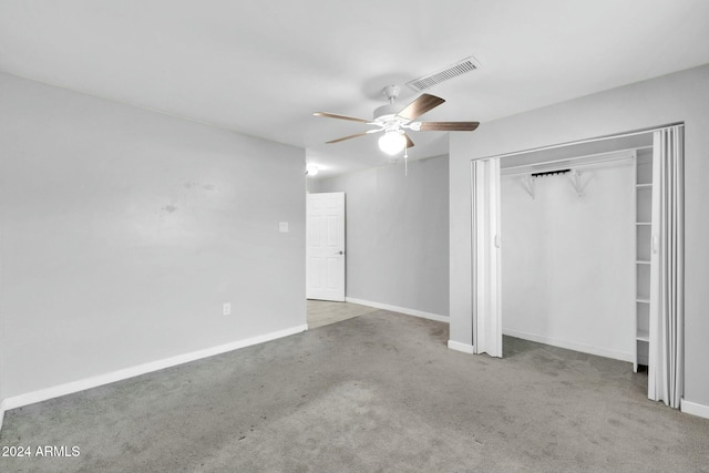 unfurnished bedroom featuring carpet, ceiling fan, and a closet