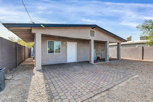 back of house with a patio