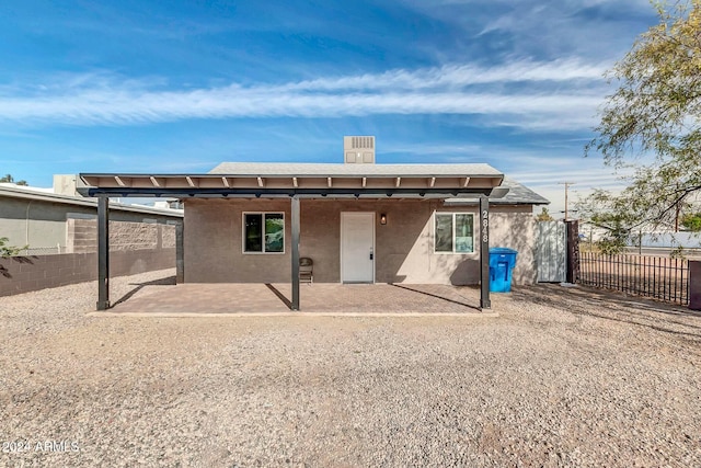 back of house with a patio