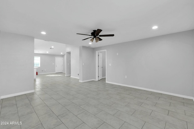 unfurnished room with light tile patterned floors and ceiling fan