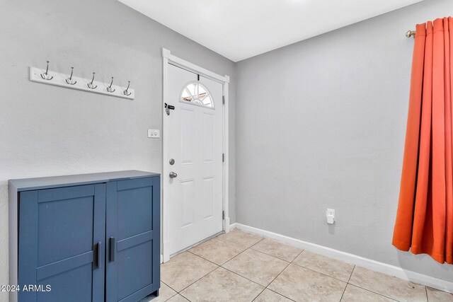 foyer entrance with light tile patterned floors