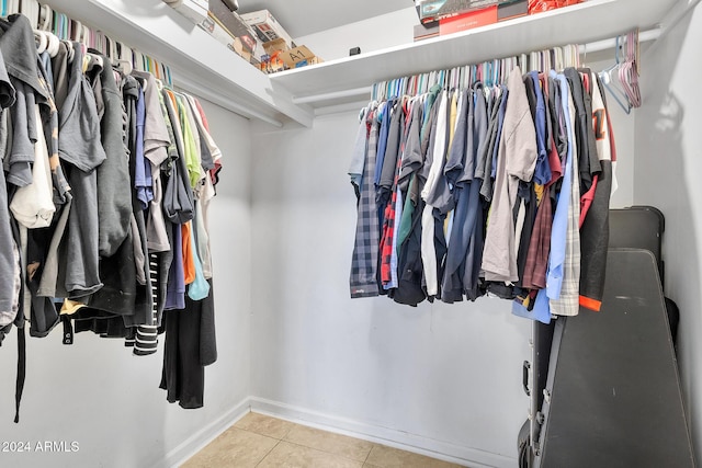 walk in closet with light tile patterned flooring