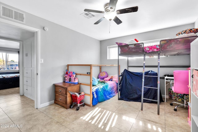 tiled bedroom featuring ceiling fan