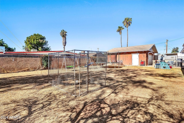 view of yard featuring a playground and a trampoline