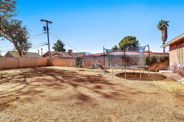 view of yard with a trampoline