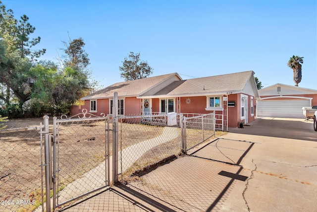 ranch-style house featuring an outbuilding and a garage