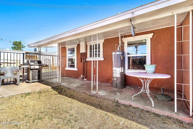 rear view of property featuring gas water heater