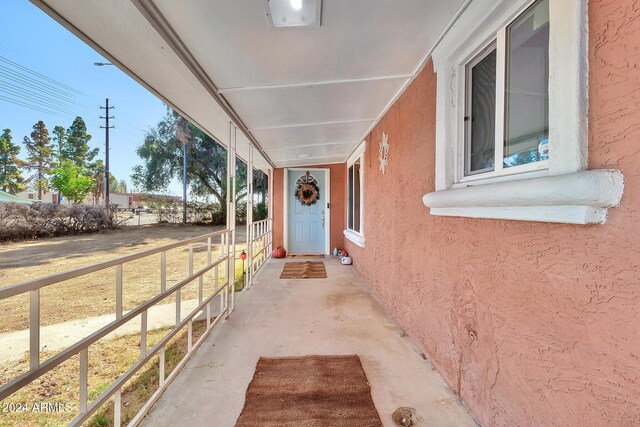 entrance to property featuring a porch