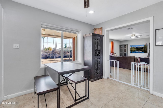 dining area with ceiling fan and light tile patterned flooring