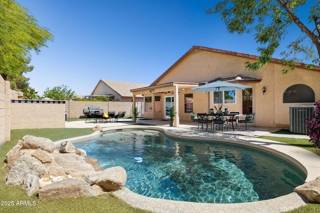 view of swimming pool with central air condition unit, fence, a patio area, and a fenced in pool