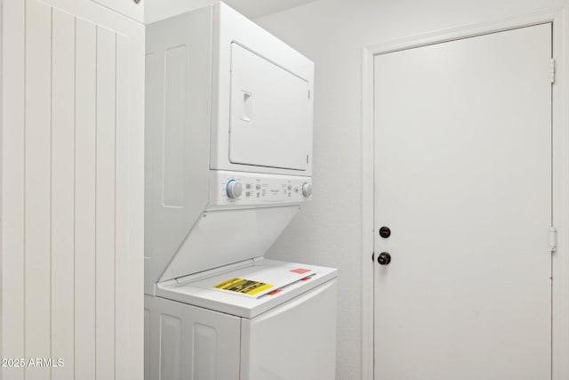 laundry room featuring stacked washer and clothes dryer and laundry area