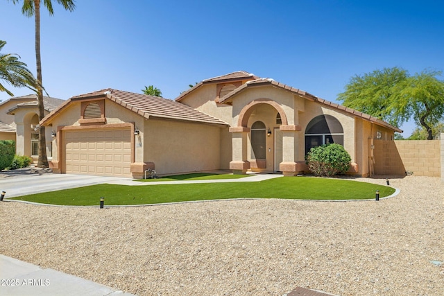 mediterranean / spanish house featuring fence, an attached garage, stucco siding, a tiled roof, and driveway