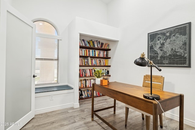 office space with baseboards and wood finished floors