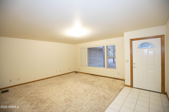 view of carpeted foyer entrance