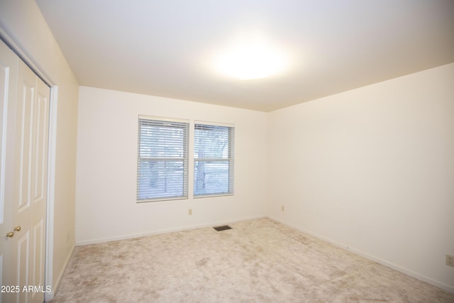 unfurnished bedroom featuring carpet and a closet