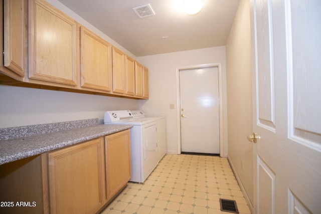 laundry room featuring cabinets and separate washer and dryer