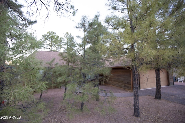 view of side of home featuring a garage