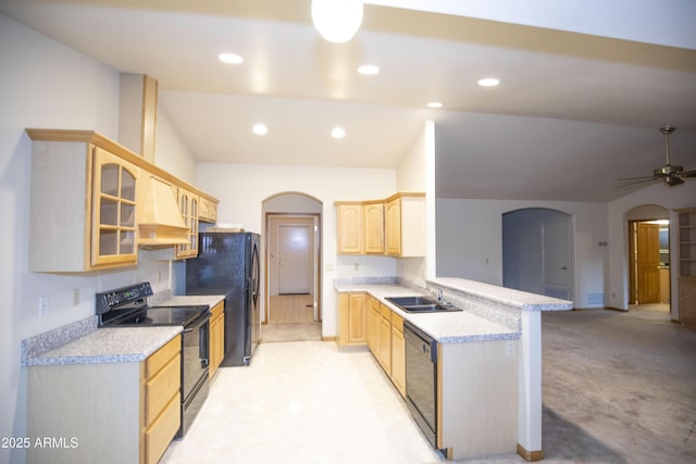 kitchen featuring kitchen peninsula, custom exhaust hood, sink, black appliances, and light brown cabinets