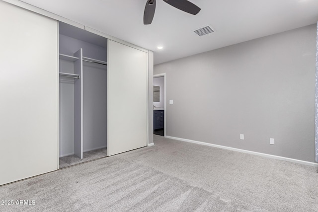 unfurnished bedroom with baseboards, visible vents, ceiling fan, a closet, and carpet flooring