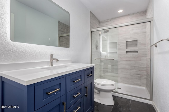 bathroom with vanity, toilet, and a stall shower