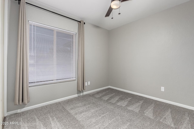 unfurnished room featuring carpet flooring, a ceiling fan, and baseboards