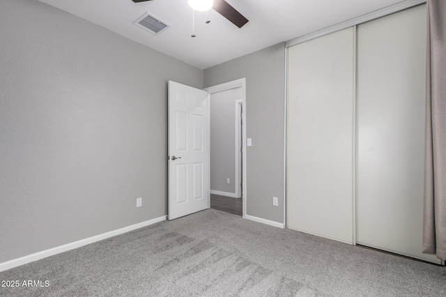 unfurnished bedroom with visible vents, baseboards, ceiling fan, carpet flooring, and a closet