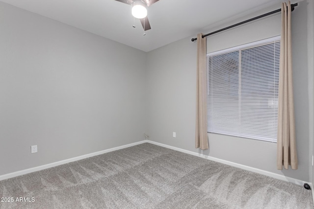 unfurnished room featuring baseboards, a ceiling fan, and carpet floors