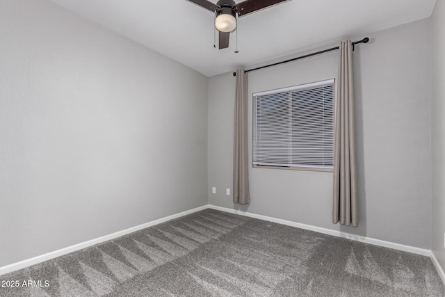 carpeted spare room featuring baseboards and ceiling fan