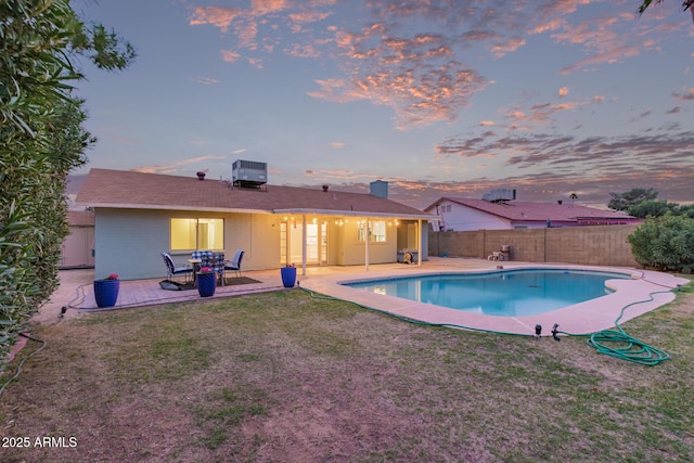 view of swimming pool featuring a fenced in pool, central AC, a fenced backyard, a yard, and a patio area