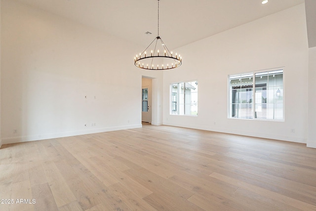 6832 N 178th Ln, Waddell, AZ 85355 - unfurnished room with an inviting chandelier, a high ceiling, and light wood finished floors