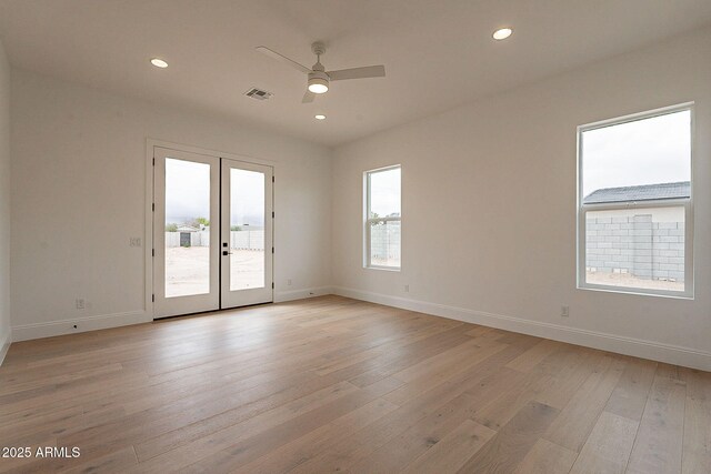 6832 N 178th Ln, Waddell, AZ 85355 - unfurnished room featuring baseboards, visible vents, light wood finished floors, ceiling fan, and french doors