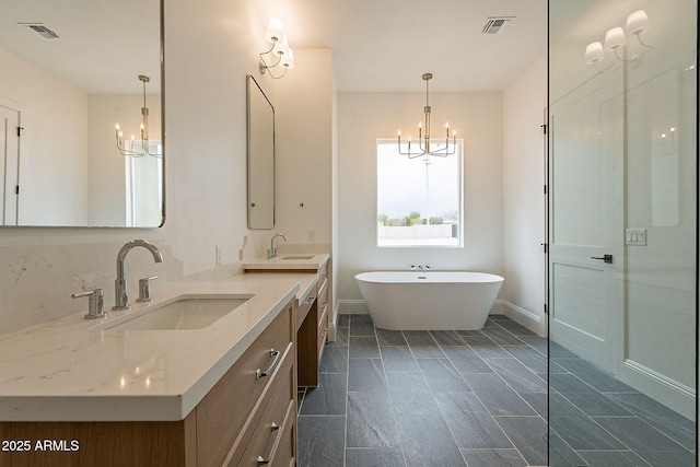 6832 N 178th Ln, Waddell, AZ 85355 - bathroom featuring an inviting chandelier, visible vents, and a sink