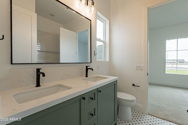 6832 N 178th Ln, Waddell, AZ 85355 - bathroom featuring double vanity, toilet, baseboards, and a sink
