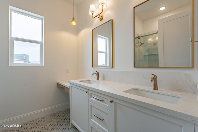 6832 N 178th Ln, Waddell, AZ 85355 - full bathroom featuring double vanity, tiled shower, baseboards, and a sink