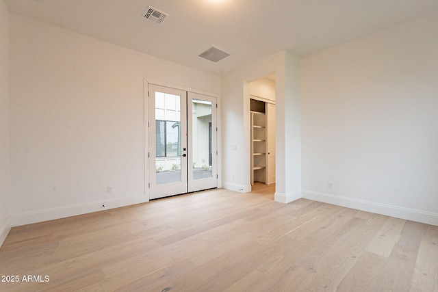6832 N 178th Ln, Waddell, AZ 85355 - empty room with visible vents, baseboards, light wood-style floors, and french doors