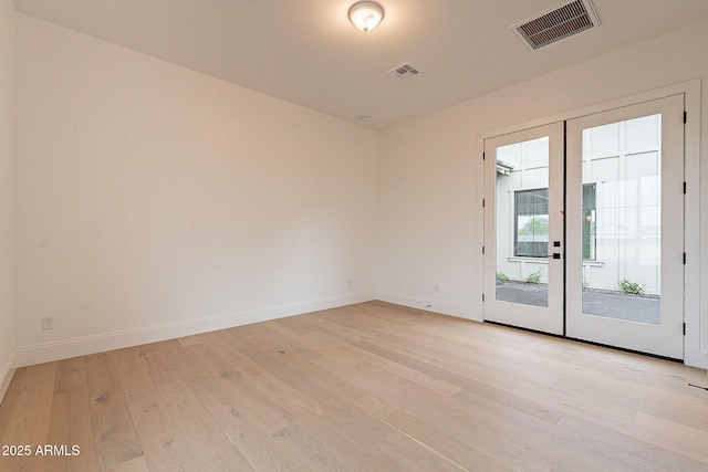 6832 N 178th Ln, Waddell, AZ 85355 - unfurnished room with light wood-type flooring, visible vents, baseboards, and french doors