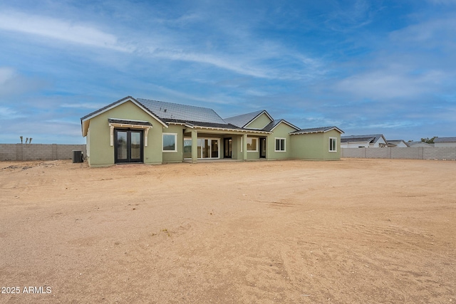 6832 N 178th Ln, Waddell, AZ 85355 - rear view of house with central AC unit, fence, stucco siding, french doors, and a tile roof