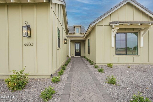 6832 N 178th Ln, Waddell, AZ 85355 - view of exterior entry featuring board and batten siding and roof with shingles