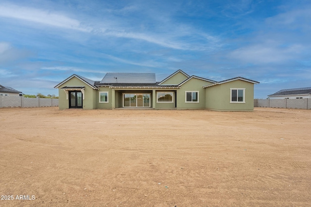 6832 N 178th Ln, Waddell, AZ 85355 - back of house with solar panels, fence, and stucco siding