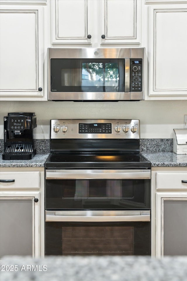 1924 S Rome St, Gilbert, AZ 85295 - kitchen featuring appliances with stainless steel finishes, white cabinets, and light stone counters