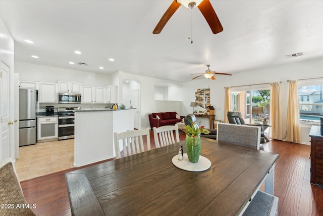 1924 S Rome St, Gilbert, AZ 85295 - dining space featuring a ceiling fan, recessed lighting, light wood finished floors, and arched walkways