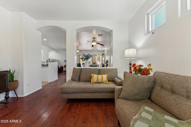 1924 S Rome St, Gilbert, AZ 85295 - living area featuring arched walkways, a ceiling fan, dark wood-style flooring, and baseboards