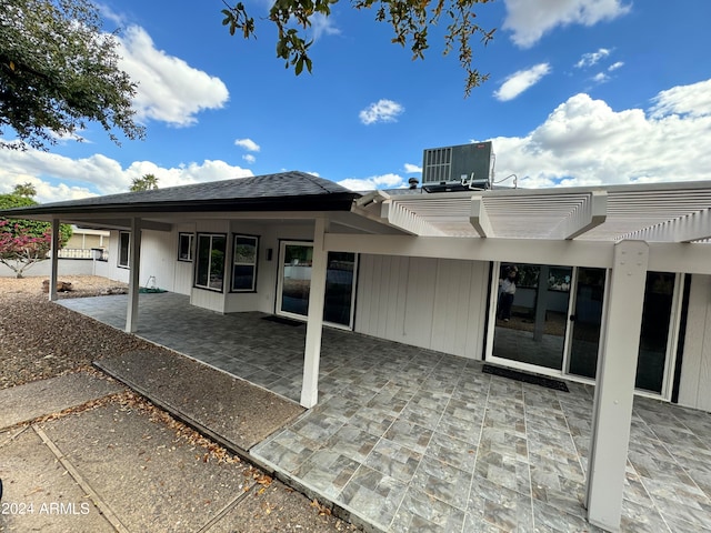 back of house with central AC unit, a patio, and a pergola