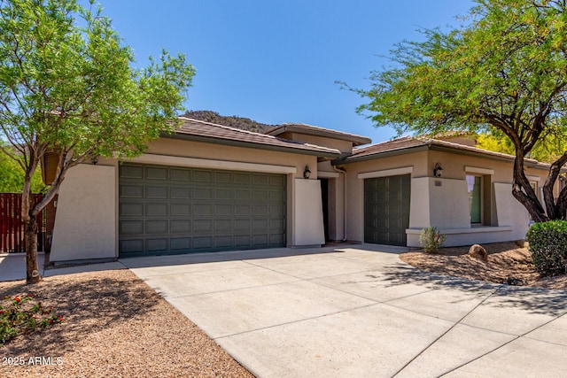 8647 W Lariat Ln, Peoria, AZ 85383 - view of front of home featuring a garage, stucco siding, and concrete driveway