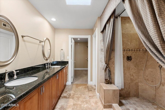 bathroom featuring vanity and a tile shower