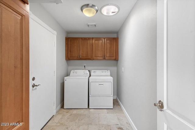 laundry room with cabinets and washer and clothes dryer