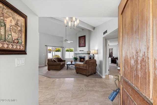 living room featuring beam ceiling and ceiling fan with notable chandelier