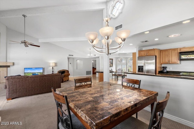 carpeted dining area featuring vaulted ceiling with beams and ceiling fan with notable chandelier