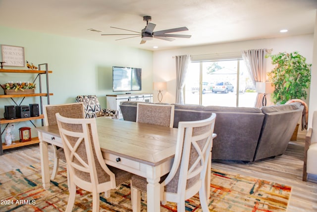 dining space featuring light hardwood / wood-style flooring and ceiling fan