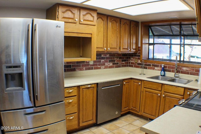 kitchen with stainless steel appliances, sink, light tile patterned floors, and backsplash